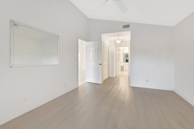 unfurnished room featuring light wood-type flooring, vaulted ceiling, and ceiling fan