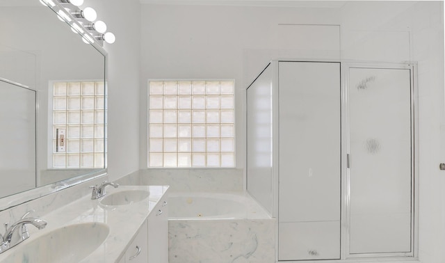 bathroom featuring vanity and independent shower and bath