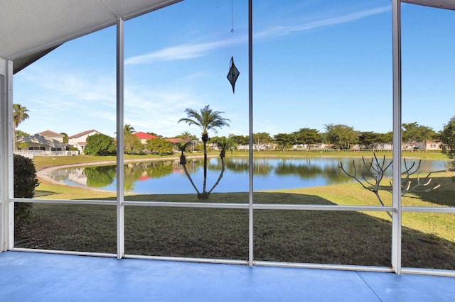 unfurnished sunroom featuring a water view