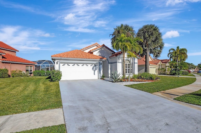 mediterranean / spanish-style home featuring a garage and a front lawn