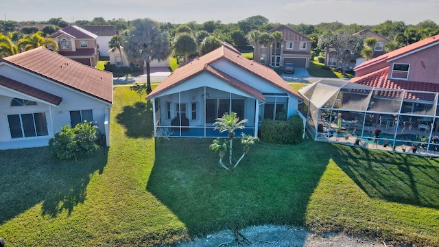 rear view of house featuring a yard