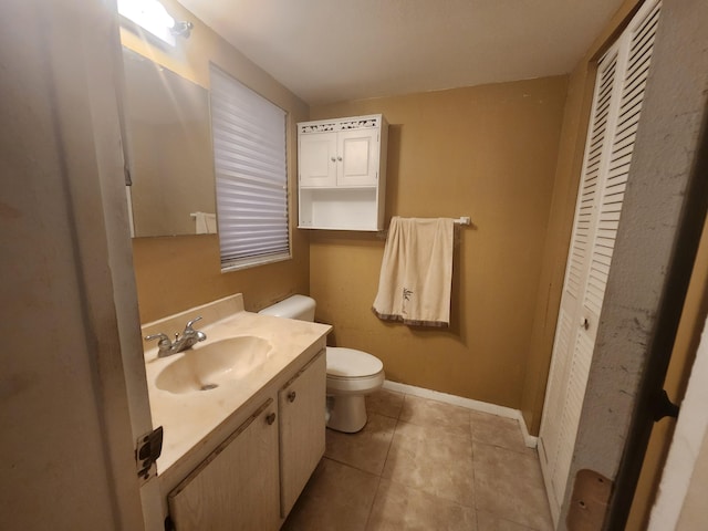 bathroom with vanity, tile patterned flooring, and toilet