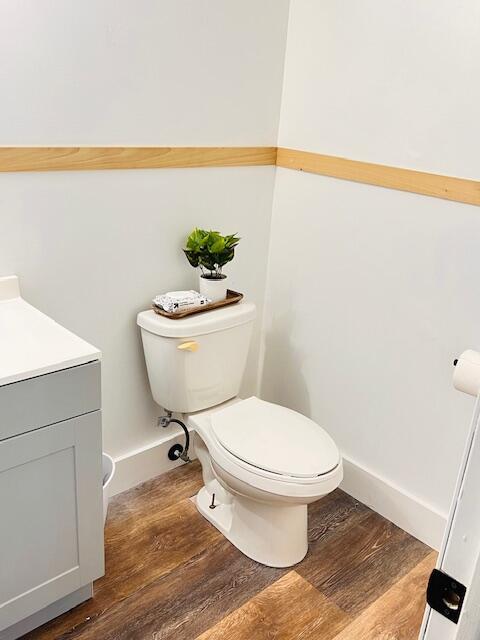 bathroom featuring hardwood / wood-style flooring, vanity, and toilet