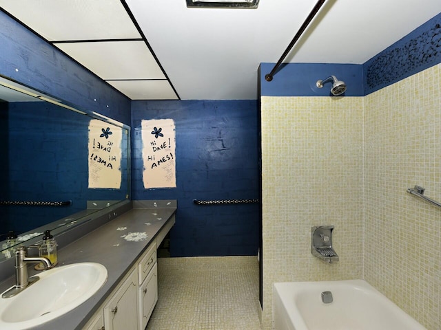 bathroom featuring tile patterned floors, vanity, and tiled shower / bath combo