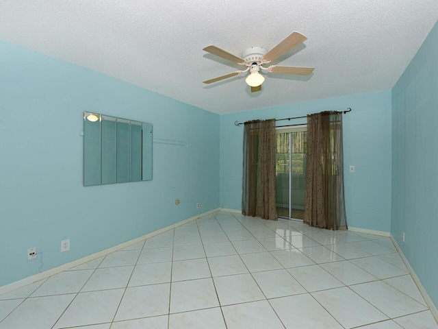 tiled spare room with ceiling fan and a textured ceiling