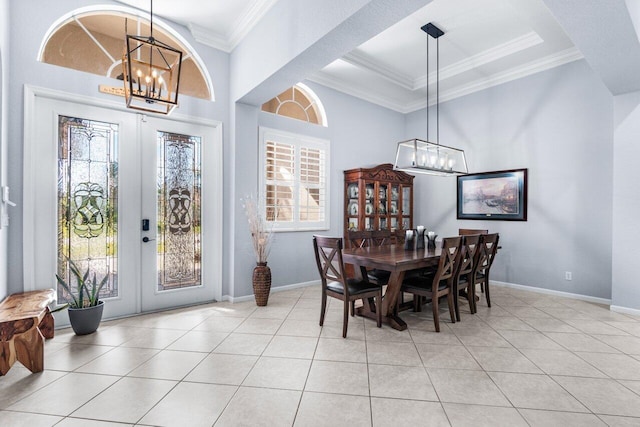 tiled dining space with ornamental molding and a notable chandelier