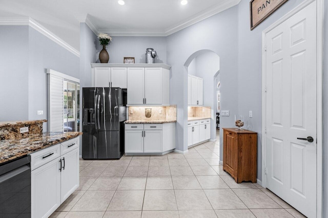 kitchen with tasteful backsplash, dark stone countertops, crown molding, white cabinets, and black appliances