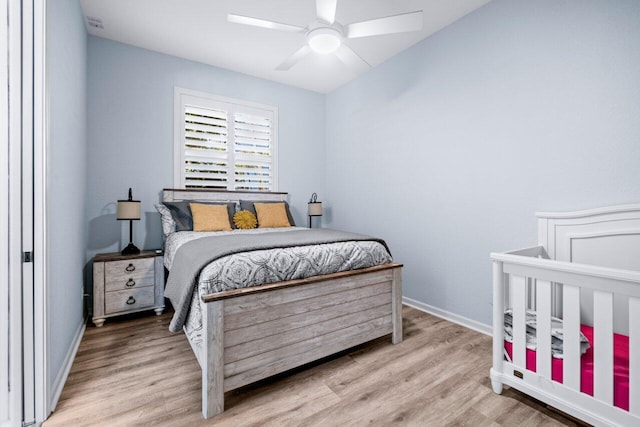 bedroom with light hardwood / wood-style floors and ceiling fan