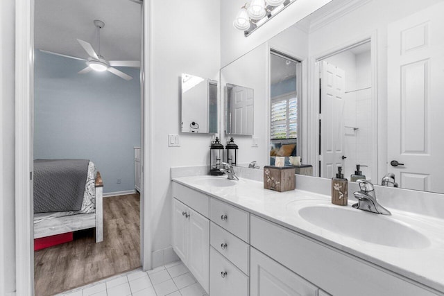 bathroom featuring ceiling fan, ornamental molding, and vanity