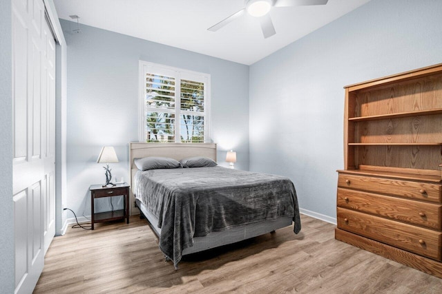 bedroom with ceiling fan, a closet, and light wood-type flooring