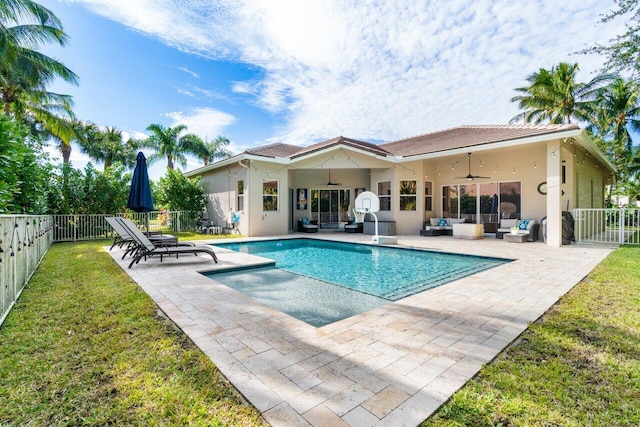 view of pool with ceiling fan, a yard, a patio, and an outdoor hangout area