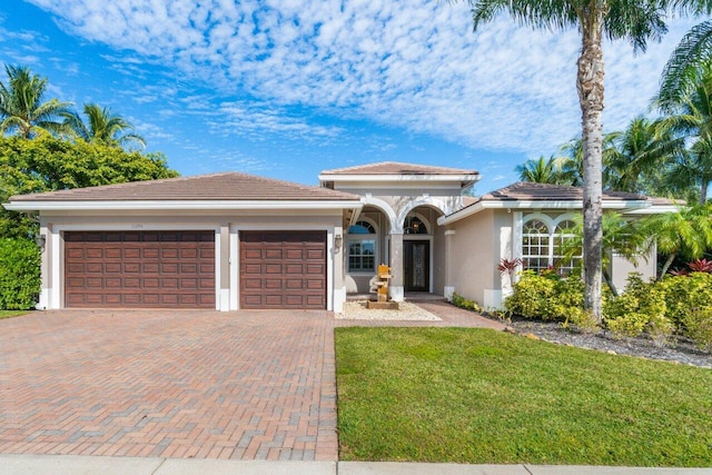 view of front of house with a front lawn and a garage