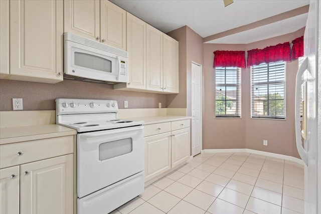 kitchen with light tile patterned floors and white appliances