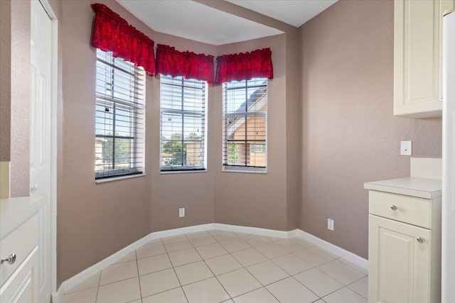 interior space featuring plenty of natural light and light tile patterned flooring