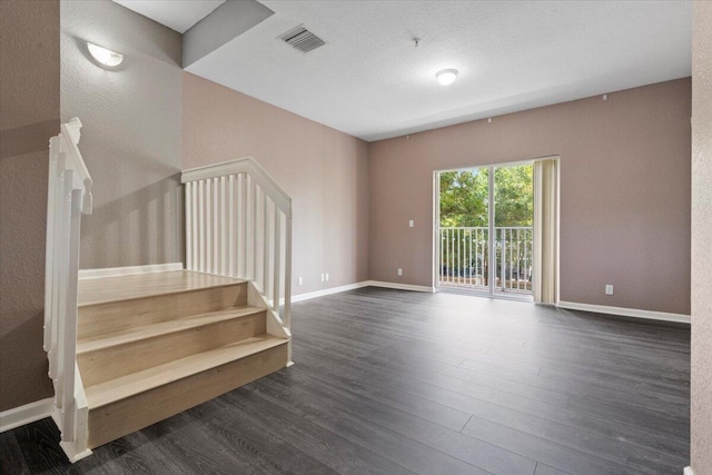 spare room featuring dark hardwood / wood-style flooring