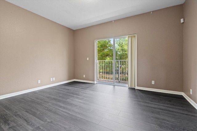 unfurnished room with dark hardwood / wood-style floors