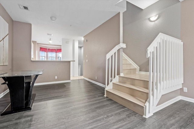 stairs with hardwood / wood-style floors