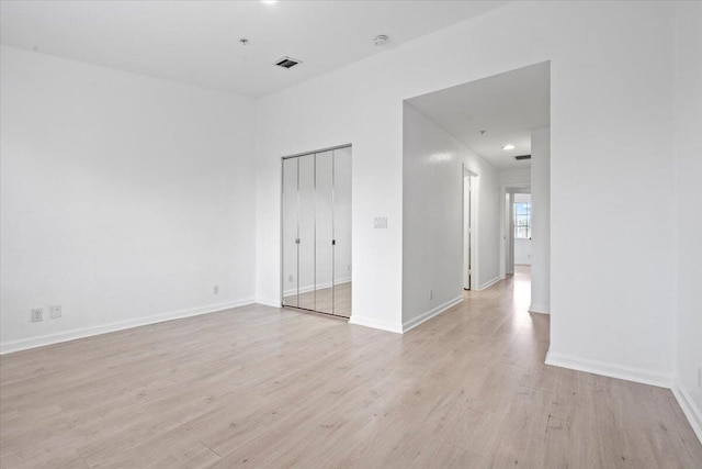 empty room with light hardwood / wood-style floors