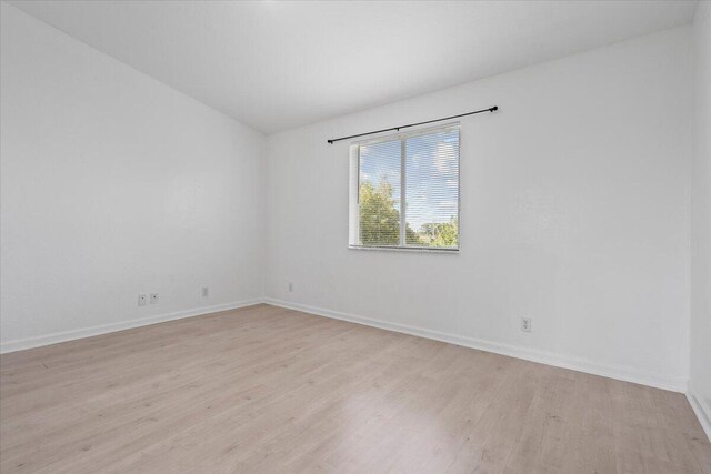 empty room with light hardwood / wood-style floors