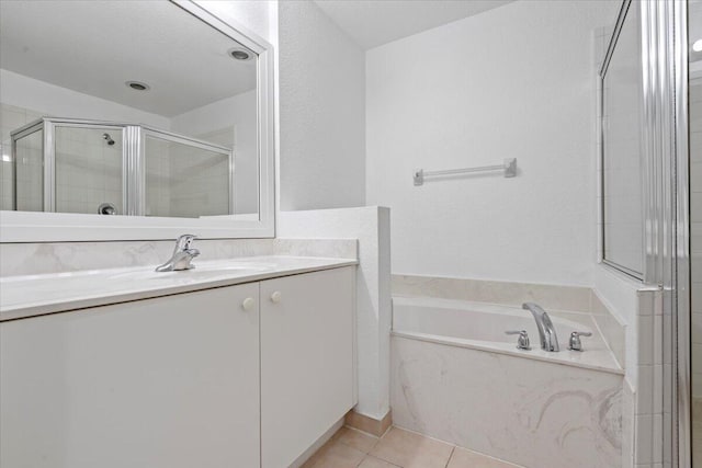 bathroom with tile patterned flooring, vanity, and independent shower and bath