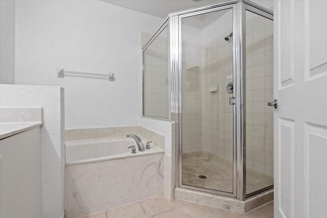 bathroom featuring tile patterned flooring, vanity, and shower with separate bathtub