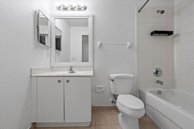 full bathroom featuring tile patterned floors, tiled shower / bath combo, toilet, and vanity