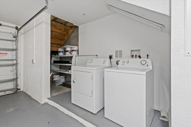 laundry room with washing machine and clothes dryer