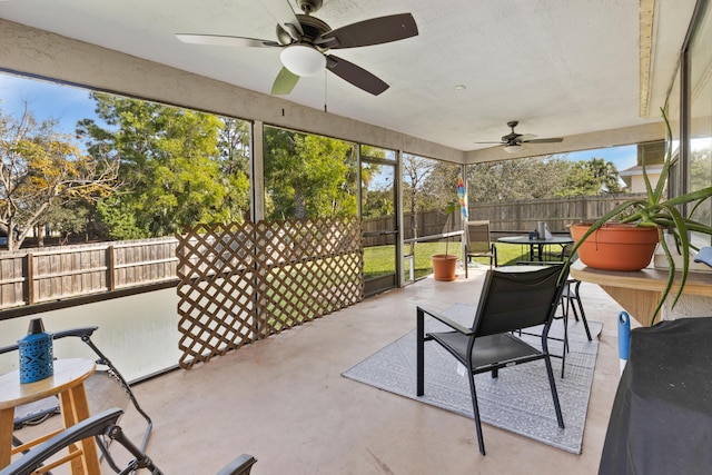 sunroom / solarium featuring ceiling fan