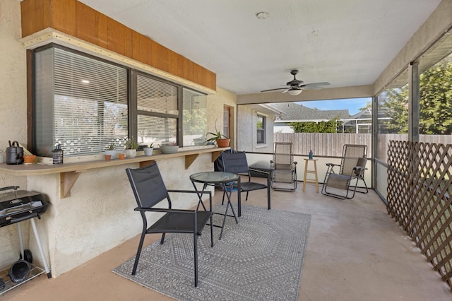 view of patio with exterior bar and ceiling fan