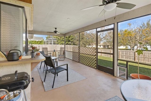 sunroom featuring ceiling fan