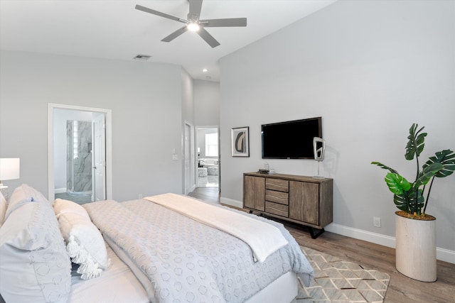 bedroom with ensuite bathroom, ceiling fan, and light hardwood / wood-style flooring