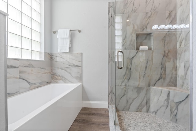 bathroom featuring hardwood / wood-style floors and independent shower and bath