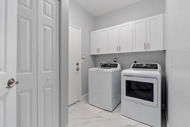 washroom featuring cabinets and independent washer and dryer