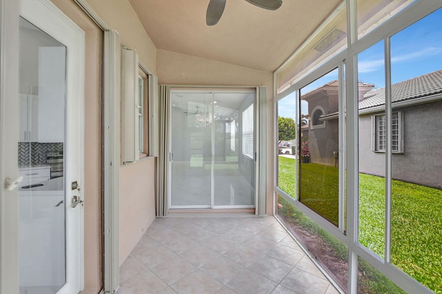 unfurnished sunroom with vaulted ceiling and ceiling fan