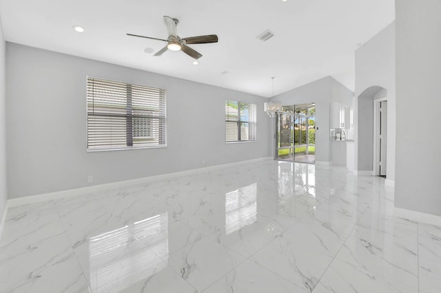 unfurnished room featuring ceiling fan with notable chandelier