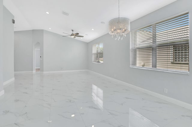 empty room featuring ceiling fan with notable chandelier