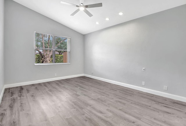 empty room with light wood-type flooring, vaulted ceiling, and ceiling fan