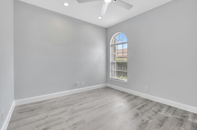 spare room with ceiling fan and light hardwood / wood-style floors