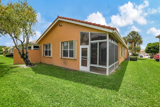 view of property exterior featuring a lawn and a sunroom