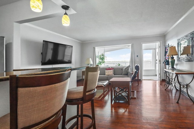 living room with a textured ceiling, dark hardwood / wood-style floors, and crown molding