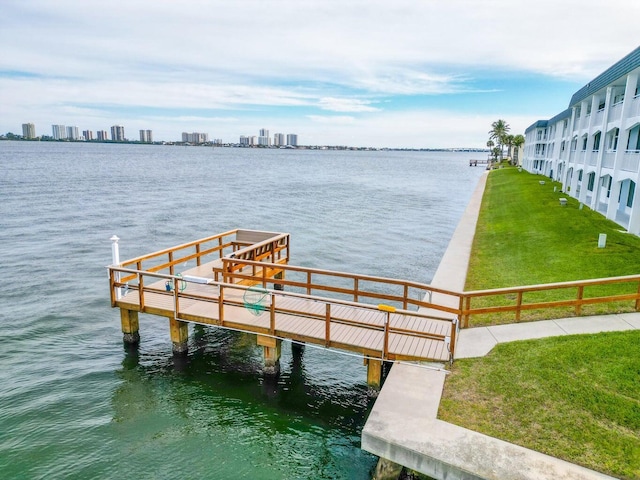 dock area with a yard and a water view