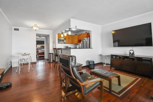 living room with a textured ceiling, ornamental molding, and dark wood-type flooring