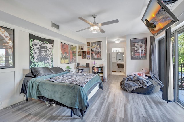 bedroom featuring hardwood / wood-style floors, ceiling fan, access to outside, and ensuite bath