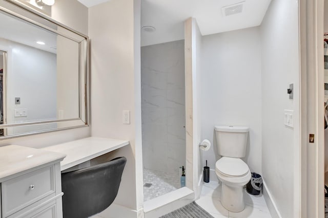 bathroom featuring vanity, toilet, and tiled shower