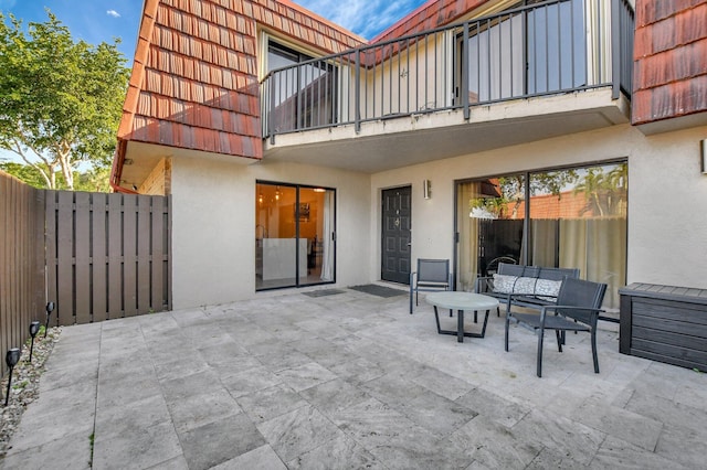 view of patio with an outdoor hangout area and a balcony