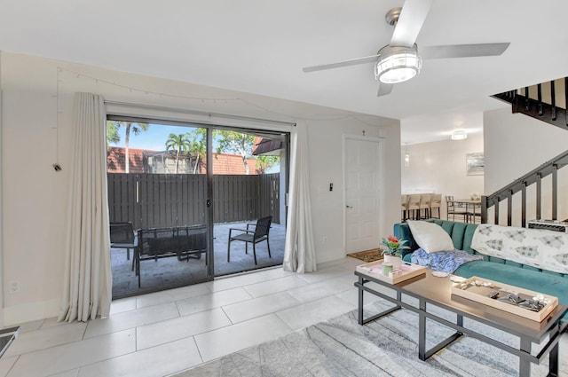 living room featuring light tile patterned floors and ceiling fan