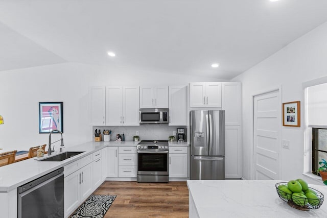 kitchen with white cabinetry, sink, lofted ceiling, and appliances with stainless steel finishes