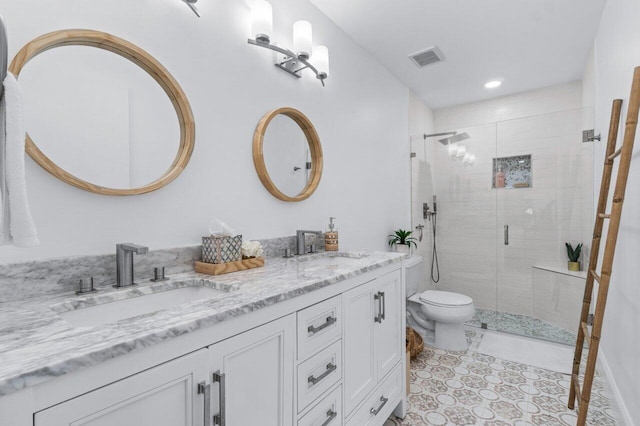 bathroom with vanity, an enclosed shower, and toilet