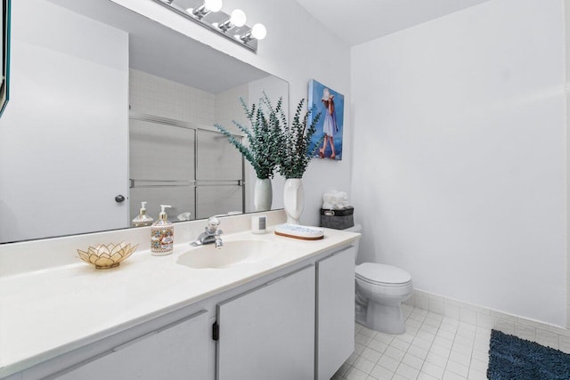 bathroom featuring tile patterned flooring, vanity, an enclosed shower, and toilet