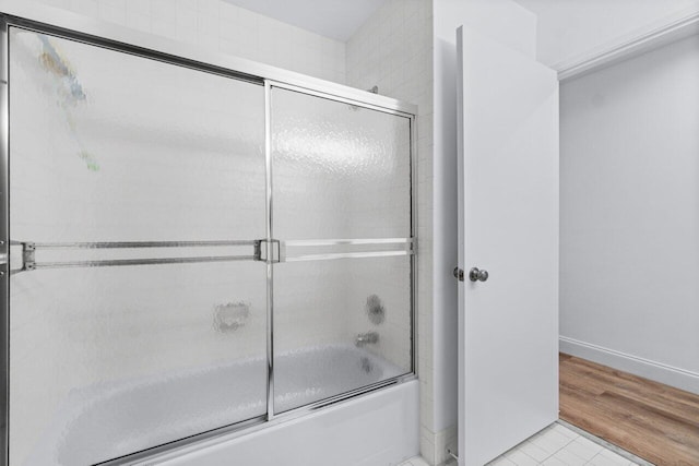 bathroom with tile patterned flooring and enclosed tub / shower combo